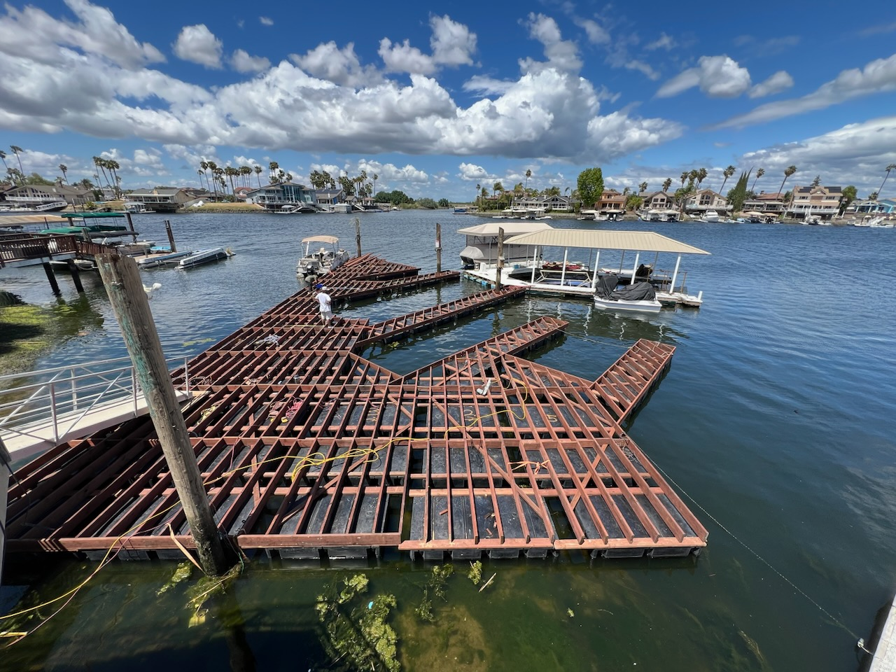 Waterfront construction work completed around an existing dock and boat slip